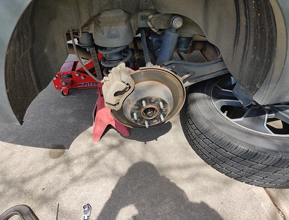 Mobile brake service van parked outside a customer’s home, offering fast, convenient auto repair.