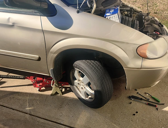 Mechanic performing a brake fluid flush to maintain brake system performance and vehicle safety in Harrisburg, NC.