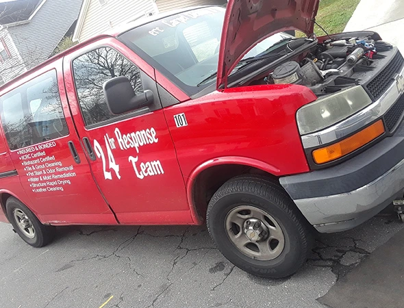 Red van with the hood open, providing mobile battery replacement and expert installation in Huntersville, NC.