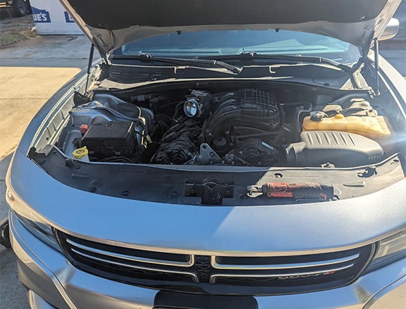 Close-up of a car engine bay during an emergency car battery replacement service in Salisbury, NC.