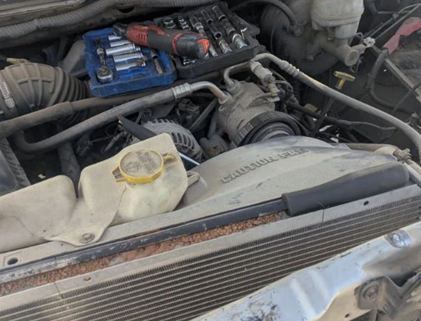 Mechanic tools and socket set on a vehicle engine during a professional engine diagnostic service in Charlotte, NC.