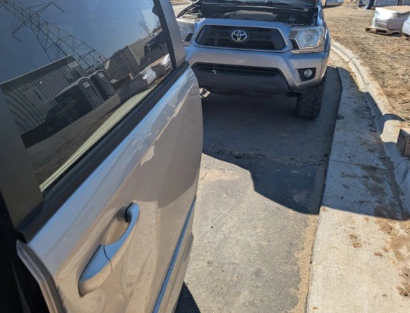 A silver vehicle parked on a residential curb during a 24/7 radiator leak detection service call in Charlotte, NC.