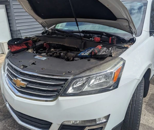 Allstar Mobile Mechanic using advanced tools for quick vehicle diagnostics on a Chevrolet engine in Charlotte.